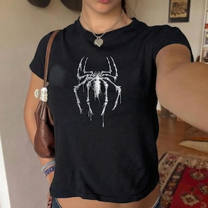 May include: A set of three ceramic mugs with a speckled, matte finish in cream, light grey, and dark grey. Each mug has a simple, modern design and a rounded handle.