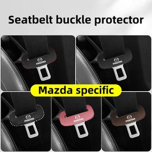 May include: Seatbelt buckle protectors for Mazda vehicles. The image shows several black protectors with the Mazda logo, in various colours including red, white, and brown. The text "Seatbelt buckle protector" and "Mazda specific" are also visible.