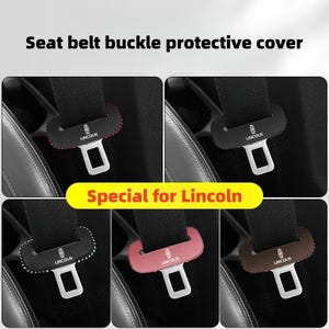 May include: Seat belt buckle protective covers in various colors, designed for Lincoln vehicles. The image shows covers in red, black, pink, brown, and black with white stitching. Each cover features the Lincoln logo and a protective design.