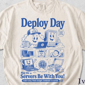 Könnte beinhalten: Elfenbeinfarbenes T-Shirt mit blauem Grafikdesign. Das Design zeigt die Worte "Deploy Day" und verschiedene Illustrationen von Computern, Wolken und Kaffeetassen. Der Satz "May the Servers Be With You!" ist ebenfalls enthalten.