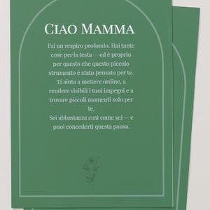 May include: A rectangular green card featuring an arched white line border and the Italian text "CIAO MAMMA" followed by a paragraph of Italian script. A small, simple line drawing of a flower is positioned at the bottom center of the card.