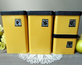 Vintage Set of Four Lincoln Beautyware Tin Canisters in Yellow Harvest Gold with Black Hammered Wrought Iron Design Style Lids 1970s