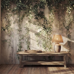 May include: A rectangular wooden bench with a lower shelf sits against a wall covered in climbing green vines with small white flowers. A ceramic table lamp with a tan shade and a shallow wooden tray are placed on the bench surface.