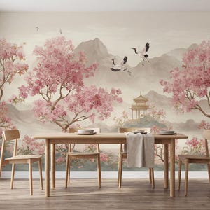 May include: A dining room featuring a wall mural with a landscape of pink cherry blossom trees, flying cranes, and a pagoda set against mountains. A light-toned wooden dining table with four matching chairs sits in front of the wall mural.