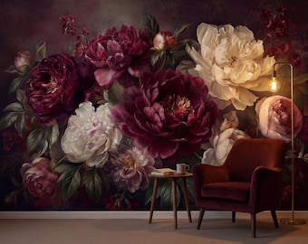 May include: A wall mural featuring a large-scale floral arrangement of deep burgundy and white peonies against a dark background. A dark red velvet armchair sits in front of the mural next to a small wooden side table with a mug and a book.