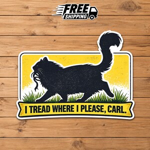 May include: A rectangular sticker featuring a black silhouette of a fluffy cat walking through green grass against a yellow background. The cat holds a small creature in its mouth. Below the cat, a yellow banner displays the text: I TREAD WHERE I PLEASE, CARL.