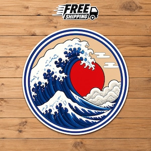 May include: A circular sticker featuring a stylized illustration of a large dark blue ocean wave cresting over a solid red sun against a light tan background. The design includes white sea foam details and simple white clouds, all enclosed within a blue border.