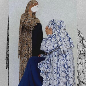 May include: Two women in patterned dresses and headscarves. One dress is brown and tan, the other is white and blue. The image includes the text "SAVANNAH COLLECTION" and a countdown timer.