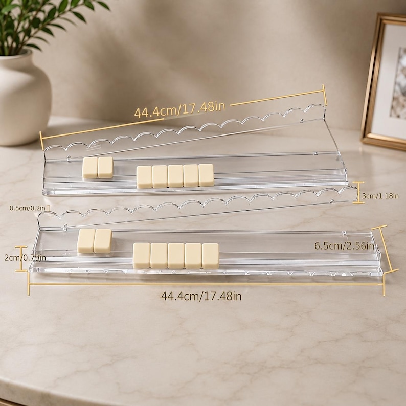 May include: Two clear acrylic shelves, each 17.48 inches long, with scalloped edges. Each shelf holds several small, rectangular, off-white objects. The shelves are 2.56 inches and 1.18 inches wide, respectively.