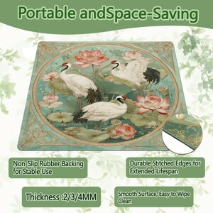 May include: A rectangular desk mat featuring a circular illustration of three white cranes among pink lotus flowers and green lily pads. The text reads Portable and Space-Saving, Non-Slip Rubber Backing for Stable Use, Durable Stitched Edges, and Thickness: 2/3/4MM.
