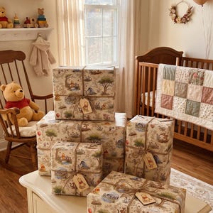 May include: Four rectangular gift boxes wrapped in beige paper featuring a repeating Winnie the Pooh pattern. Each package is tied with brown twine and includes a small wooden gift tag shaped like Winnie the Pooh, Piglet, or Eeyore.