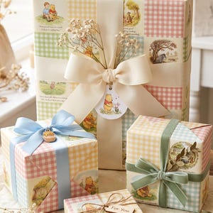 May include: Four gift boxes wrapped in Winnie the Pooh themed paper featuring pastel gingham patterns and illustrations of characters. The boxes are decorated with ribbons in cream, light blue, and sage green, plus a wooden tag labeled For You.