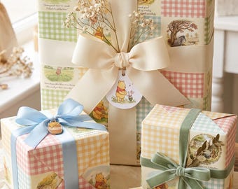 May include: Four gift boxes wrapped in Winnie the Pooh themed paper featuring pastel gingham patterns and illustrations of characters. The boxes are decorated with ribbons in cream, light blue, and sage green, plus a wooden tag labeled For You.