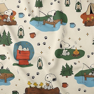 May include: Cream-coloured fabric with a repeating pattern of Snoopy camping scenes. Snoopy is shown fishing, toasting marshmallows, and relaxing by a campfire. The design includes tents, trees, lanterns, and paw prints.