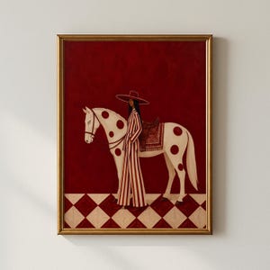 May include: A framed painting featuring a person in a wide-brimmed hat and a red and white striped suit standing beside a white horse with large red polka dots. The horse wears a brown saddle. The background is deep red over a red and white diamond floor.
