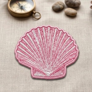 May include: A pink and white embroidered seashell patch. The patch features a detailed design with radiating lines and a scalloped edge. The seashell is a light pink color with white accents, creating a textured appearance. This patch is suitable for clothing or craft projects.