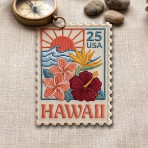 May include: Embroidered patch resembling a vintage 25-cent USA postage stamp. The design features a sunrise, ocean waves, and tropical flowers, including hibiscus and bird of paradise. The word "HAWAII" is at the bottom.