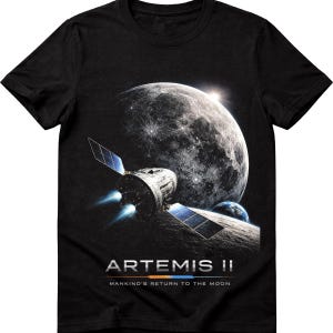 May include: Black t-shirt featuring a space scene with a large, detailed moon, a spacecraft with solar panels, and the Earth. The text "ARTEMIS II" and "MANKIND'S RETURN TO THE MOON" are printed below the image.