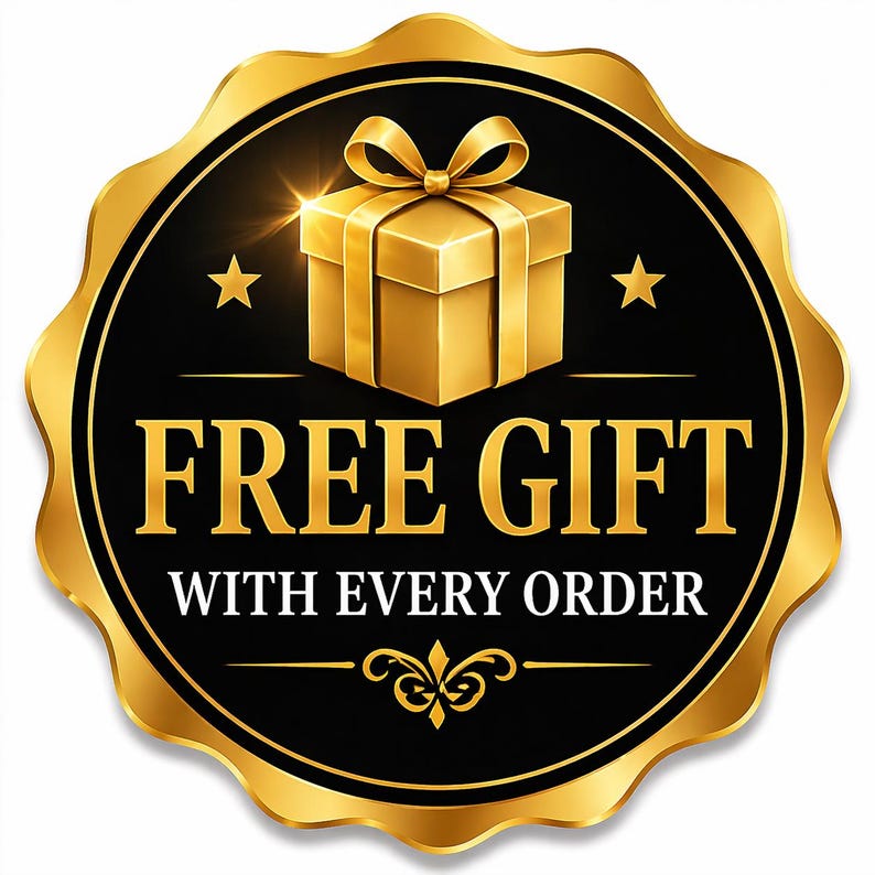 May include: A circular gold and black emblem featuring a gold gift box with a bow at the top, two small gold stars, and the text "FREE GIFT" in large gold letters followed by "WITH EVERY ORDER" in smaller white letters, with a decorative gold flourish.