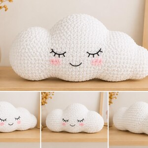 May include: A white, crocheted cloud-shaped pillow with closed eyes, pink cheeks, and a smiling mouth. The pillow is designed for decorative purposes and adds a whimsical touch to any room. The pillow is approximately 15 inches long.