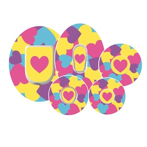 May include: A collection of colorful heart-themed stickers and a device. The stickers feature a pattern of yellow, pink, purple, and blue hearts. The device and stickers have a pink heart on a yellow background.