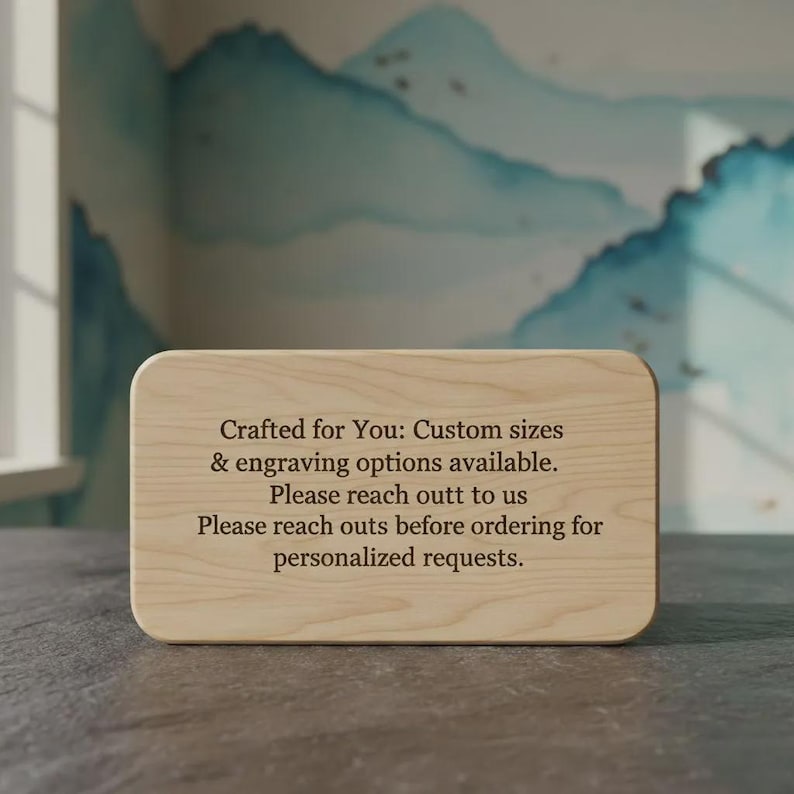 Pode incluir: Uma placa retangular de madeira clara com cantos arredondados, apresentando um texto gravado escuro que diz: Crafted for You: Custom sizes & engraving options available. Please reach out to us. Please reach outs before ordering for personalized requests.