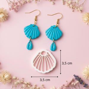 May include: Turquoise seashell earrings with gold-coloured hooks and a matching teardrop charm. A white seashell-shaped cutter, 3.5 cm in size, is also shown. The earrings and cutter are displayed on a pink background with floral accents.