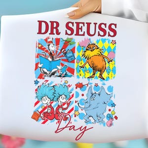 May include: White tote bag featuring a colorful Dr. Seuss design. The design includes illustrations of the Cat in the Hat, the Lorax, Thing 1 and Thing 2, and an elephant. The words "DR SEUSS Day" are printed in red.