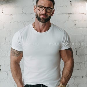 Bella Canvas 3001 Mockup, White Tee on Glasses Model, Bright Studio Brick Background, Clean Apparel Branding Photo, Modern Mockup Picture