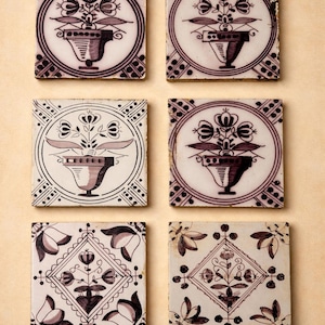 May include: A white ceramic mug with a black handle and the text "But First, Coffee" in a handwritten style. The mug is on a white surface. The mug is approximately 10 cm tall.