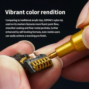 May include: A gold metallic paint marker with a nylon tip applying paint to a small, dark grey, textured plastic component. The text reads: Vibrant colour rendition. Comparing to traditional acrylic tips, DSPIAE's nylon tip used on its markers features more fluent paint flow, smoother coating and finer metal particles, further enhanced by self-leveling formula, even rookie users can easily achieve a stunning pro finish.
