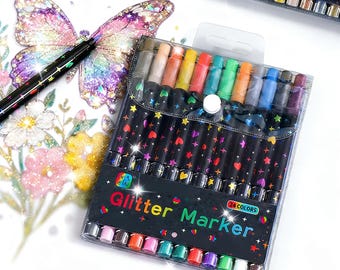 May include: A set of 24 glitter markers in a clear plastic pouch with a snap closure. The black marker barrels feature colorful heart and star patterns. The front label reads Glitter Marker 24 COLORS. One marker is shown drawing a butterfly.