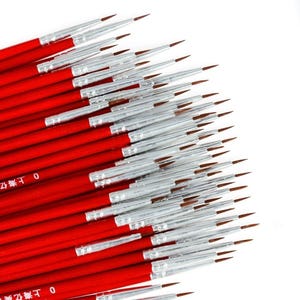 May include: A collection of fine-tipped paint brushes with red handles and silver ferrules. The bristles are a dark brown color. The brushes are arranged in a diagonal pattern against a white background, suggesting a set for detailed art projects.
