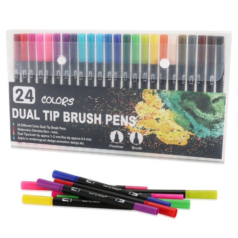 Op de afbeelding: Een set van 24 dual-tip brushpennen in een doorzichtige plastic hoes. De verpakking bevat de tekst 24 COLORS DUAL TIP BRUSH PENS en toont iconen voor een fineliner en een penseelpunt. Verschillende pennen liggen voor de verpakking.