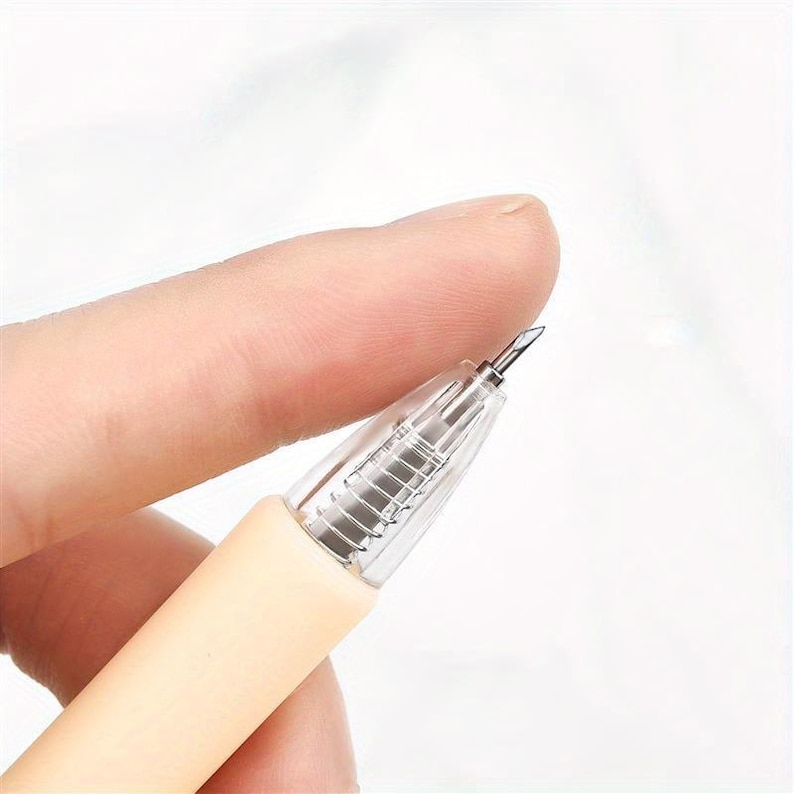 May include: A craft tool featuring a light beige handle and a clear plastic conical tip. The tool has a small, sharp, angled metal blade at the very end, designed for precision cutting or weeding tasks in various crafting and hobby projects.