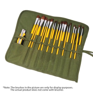 Puede incluir: Un rollo de pinceles de lona verde con múltiples ranuras, que contiene pinceles con mango amarillo y cerdas marrones. Un cúter está en un bolsillo lateral. El texto en la parte inferior indica que los pinceles son solo para exhibición.