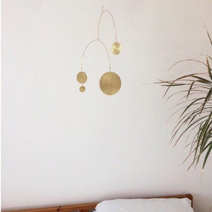 Wren kinetic handmade modern stylish interior mobile in brass