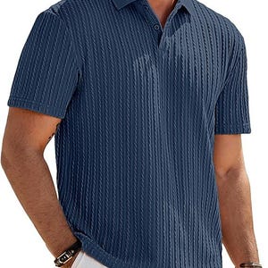 May include: A short-sleeved navy blue polo shirt featuring a vertical ribbed texture throughout the fabric. The shirt includes a classic collar and a buttoned placket at the neckline, providing a structured look with a consistent dark blue color.
