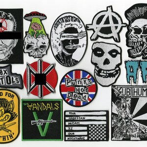 May include: A collection of embroidered patches featuring various punk rock band logos, skulls, and political slogans. Designs include the Sex Pistols, AFI, Subhumans, and The Vandals, alongside symbols like the anarchy sign and a Union Jack flag.