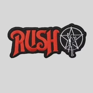 May include: A rectangular embroidered patch featuring the word RUSH in bold red lettering with a black border. To the right of the text is a circular black emblem containing a white five-pointed star and a white silhouette of a person.