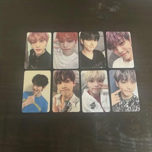 May include: Eight rectangular photo cards featuring different young people with various hairstyles and expressions. The cards are arranged in two rows of four. The individuals are wearing a variety of clothing, including t-shirts and jackets.