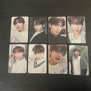 May include: A set of three ceramic mugs with a speckled, matte finish. The mugs are in shades of cream, light gray, and dark gray. Each mug has a simple, minimalist design and a rounded handle.