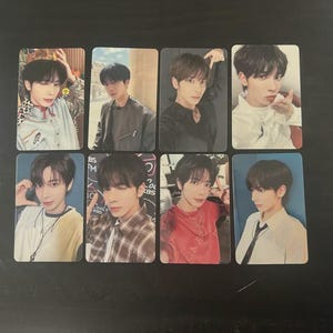 May include: A collection of eight rectangular photo cards featuring a young person in various poses and outfits. The cards showcase the person in different settings, wearing shirts, jackets, and accessories. The cards are on a dark surface.