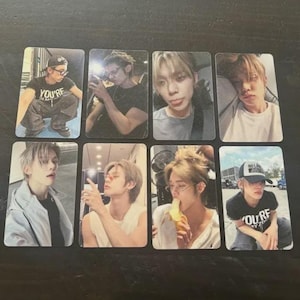 May include: Eight rectangular photo cards featuring images of a person in various poses and settings. The person is wearing different outfits and accessories, including hats and glasses. Some cards have text, including "YOU'RE" and "NO LA JUST".