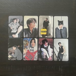 May include: Eight rectangular photo cards featuring different individuals in various poses. One card shows a person with a yellow bag with the word "YAWN". Another card shows a person wearing a red and white basketball jersey.