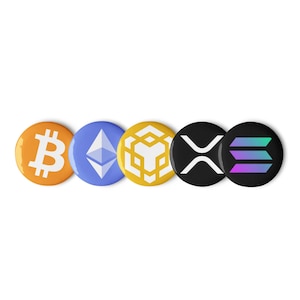 May include: A collection of five round pinback buttons featuring cryptocurrency logos. The buttons display the Bitcoin, Ethereum, Binance, Ripple, and Solana symbols in various colors, including orange, blue, yellow, black, and green.