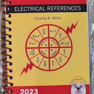 May include: A spiral-bound reference book titled Ugly's Electrical References 2023 Edition by Charles R. Miller. The cover is red and yellow with a central circular diagram showing electrical formulas for watts, volts, amps, and ohms.
