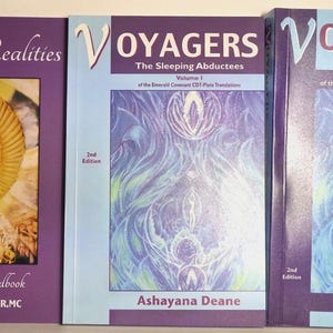 May include: Three books by Ashayana Deane with purple covers. The first is titled Angelic Realities: The Survival Handbook. The second and third are Voyagers: The Sleeping Abductees Volume I and Voyagers: The Secrets of Amenti Volume II, 2nd Editions.