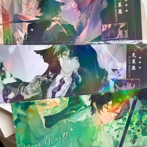 May include: Three rectangular bookmarks featuring anime-style illustrations of a character with dark hair. The designs include holographic accents, the name Klein Moretti in cursive script, and Chinese characters. Each bookmark displays a distinct scene.