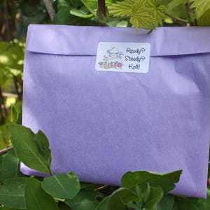 May include: A lavender-colored tissue paper envelope with a white sticker that says "Ready? Steady? Knit!"